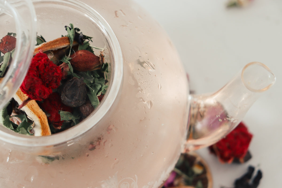 a tea pot filled with a mixture of dried flowers