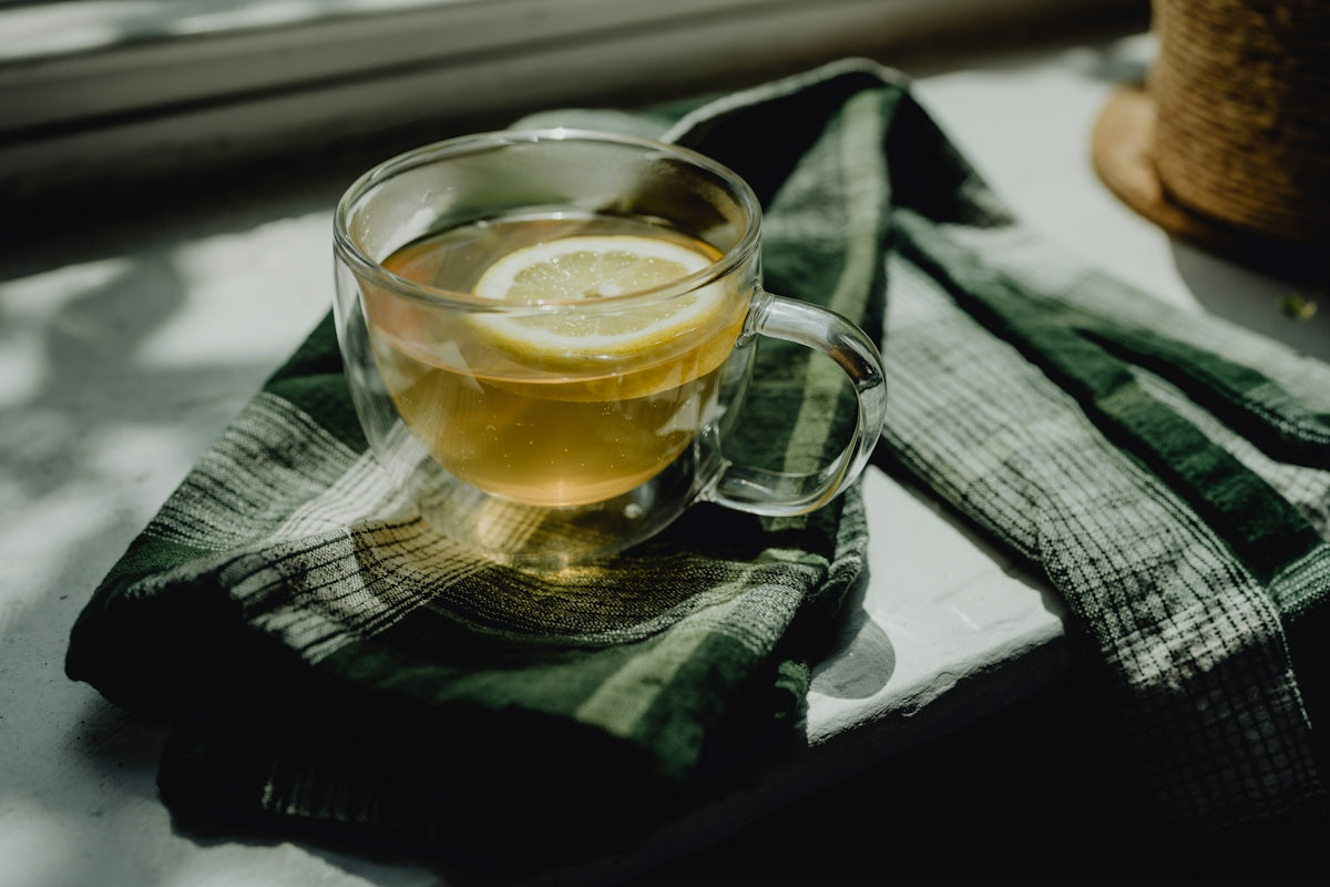 a cup of tea with a slice of lemon on a napkin