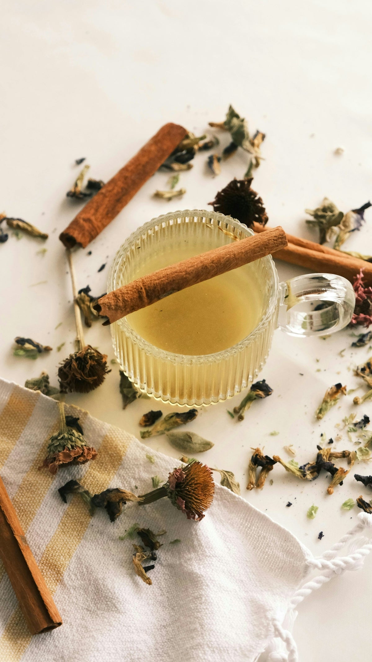 A cup of tea with a cinnamon stick next to it
