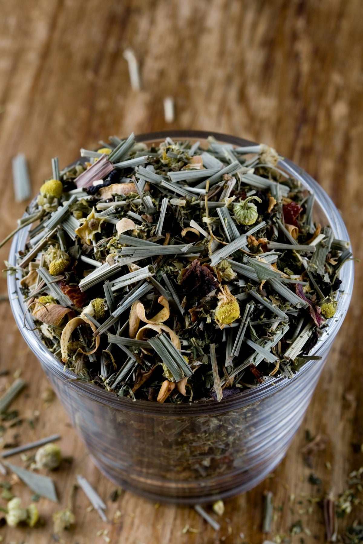 A cup filled with green tea sitting on top of a wooden table