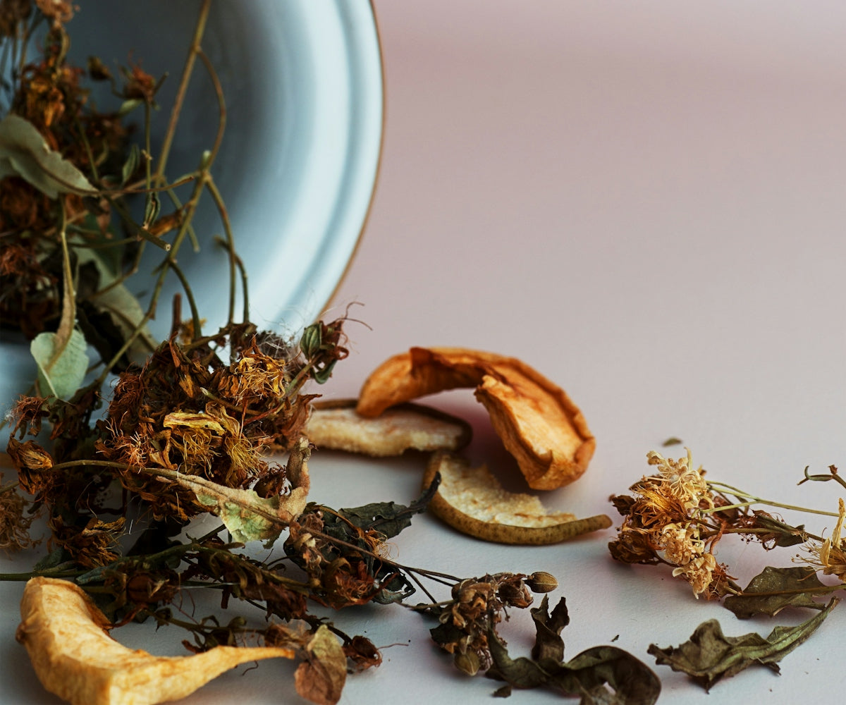 A bowl filled with dried flowers and leaves